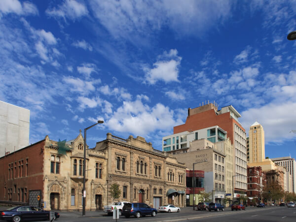 Building, Metropolitan area, Daytime, City, Sky, Residential area, Town, Neighbourhood, Architecture, Human settlement, Urban area, Mixed-use, Landmark, Metropolis, Facade, Property, Downtown, Public space, Commercial building, Plaza, North Terrace, Bonython Hall