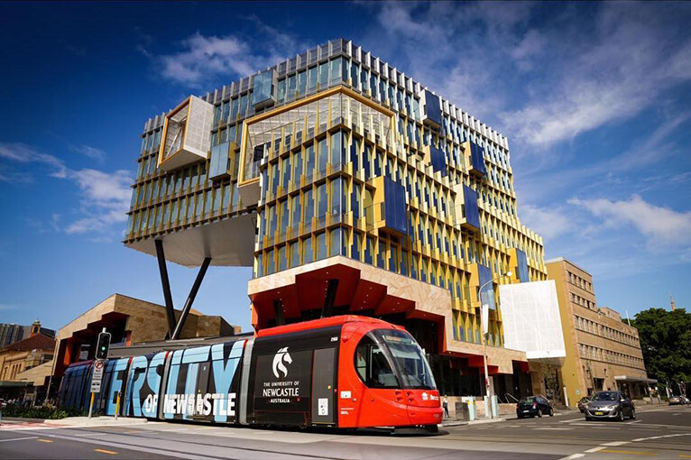 Transport, Architecture, Mode of transport, Landmark, Residential area, Building, Metropolitan area, Mixed-use, Town, Urban area, Vehicle, Commercial building, Public transport, Neighbourhood, Condominium, Facade, City, Bus, Metropolis, Double-decker bus, University of Newcastle, University of Northumbria, Newcastle University, UNSW Sydney, University of Melbourne, Northumbria University, University of Newcastle, University, Durham University, University of the Thai Chamber of Commerce, Master of Business Administration